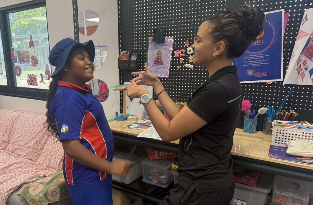 A Stars Mentor from Driver Primary School in Palmerston, NT, shares a friendly and lighthearted moment with a student.